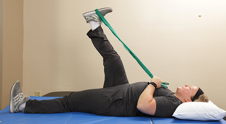 A patient demonstrates the second part of the hamstring stretch